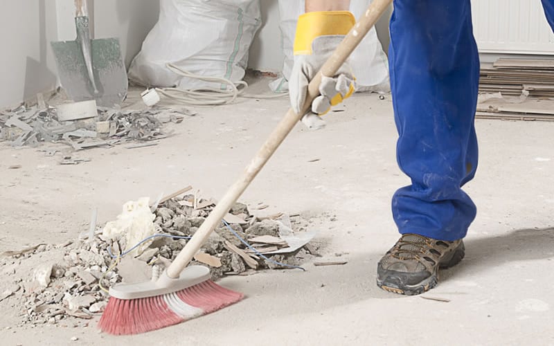 Post Construction Cleaning Service Johns Creek - sweeping up debris on job site